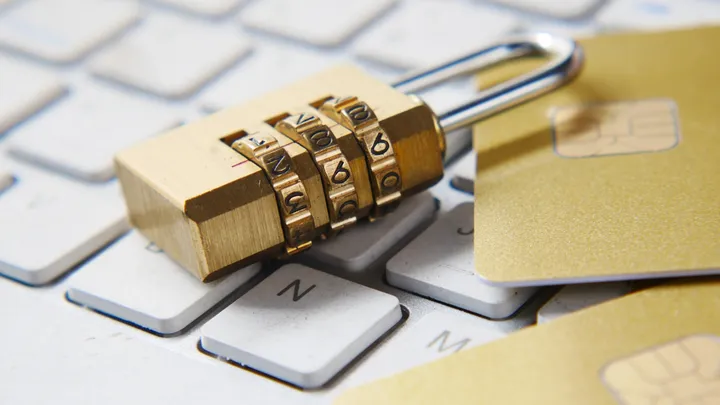 A browser address bar padlock rendered over web code, representing a web framework security patch