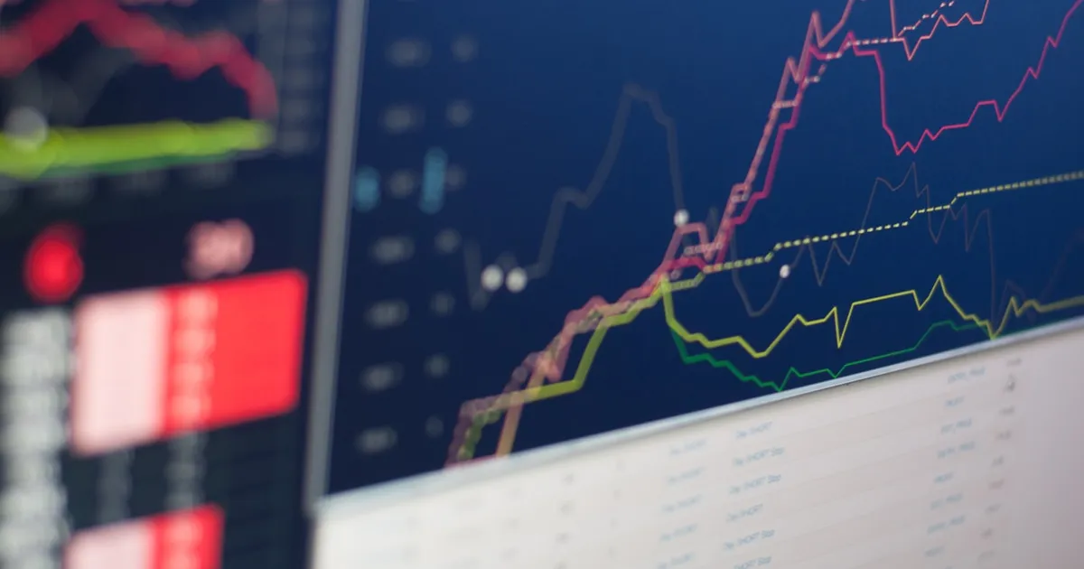 A stock market display board showing rows of ticker symbols and price movements