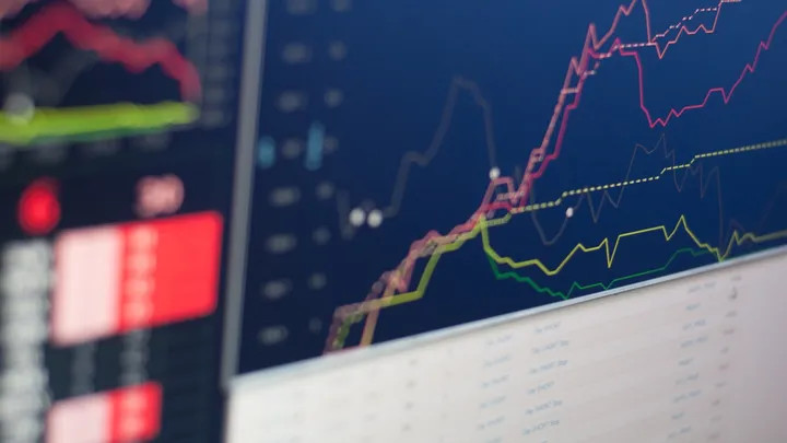 A financial markets board displaying stock prices and index levels