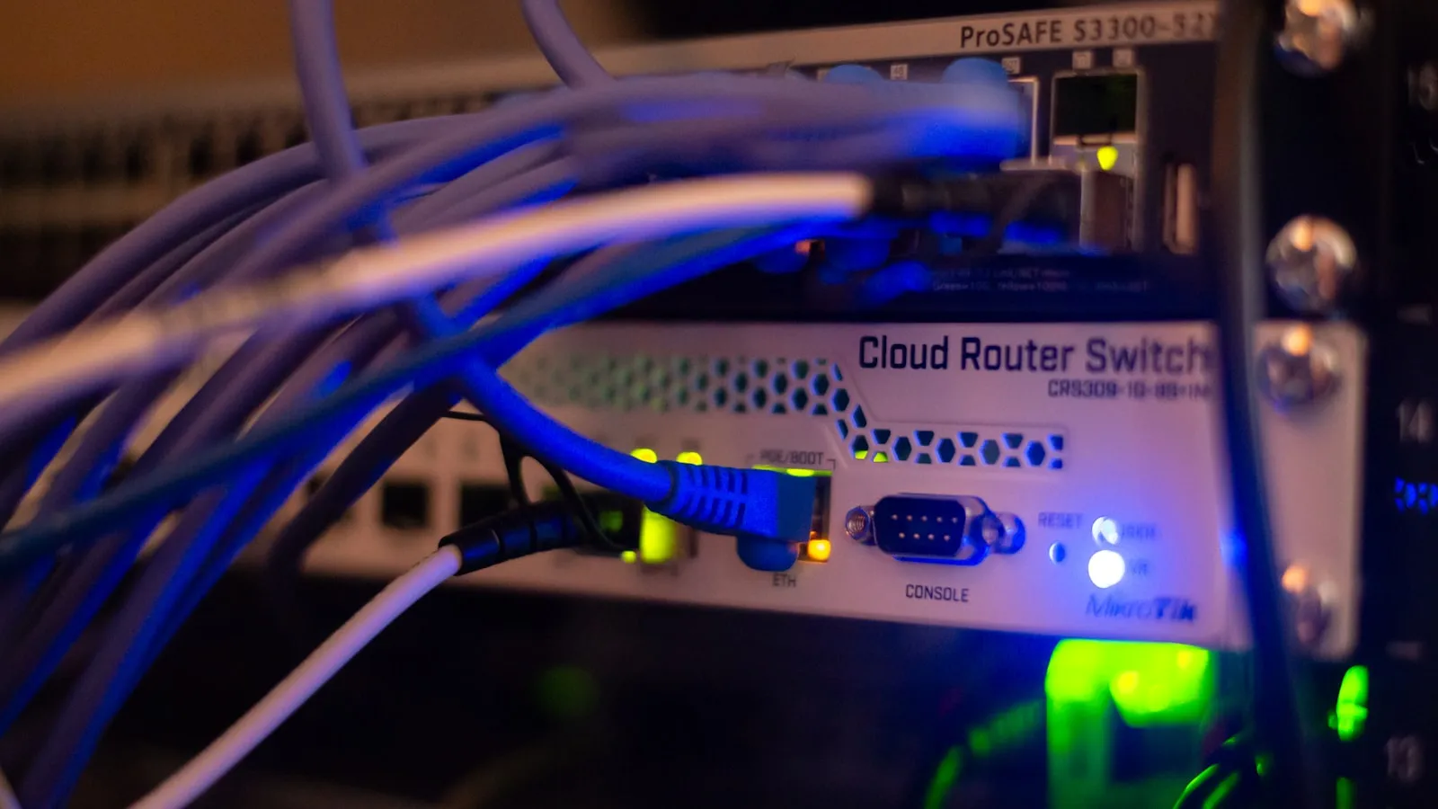 Blue network cables plugged into a rack-mounted switch