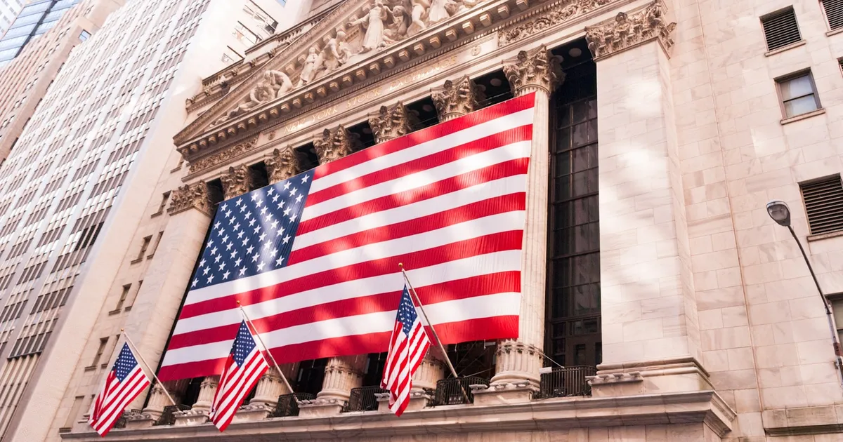 An American flag displayed on the facade of a stock exchange building