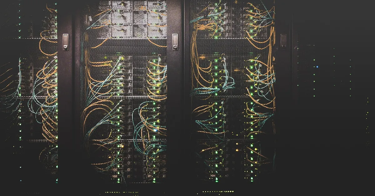 Rows of server racks with dense bundles of network cabling in a data center