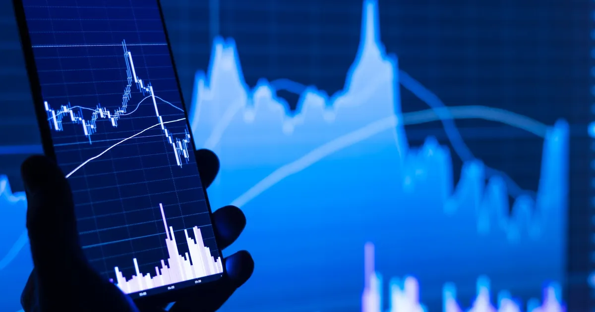 A smartphone displaying a stock market app with price charts