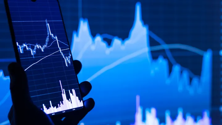 A smartphone displaying a stock market app with price charts