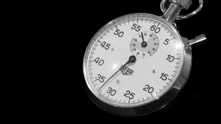 A black stopwatch on a dark surface